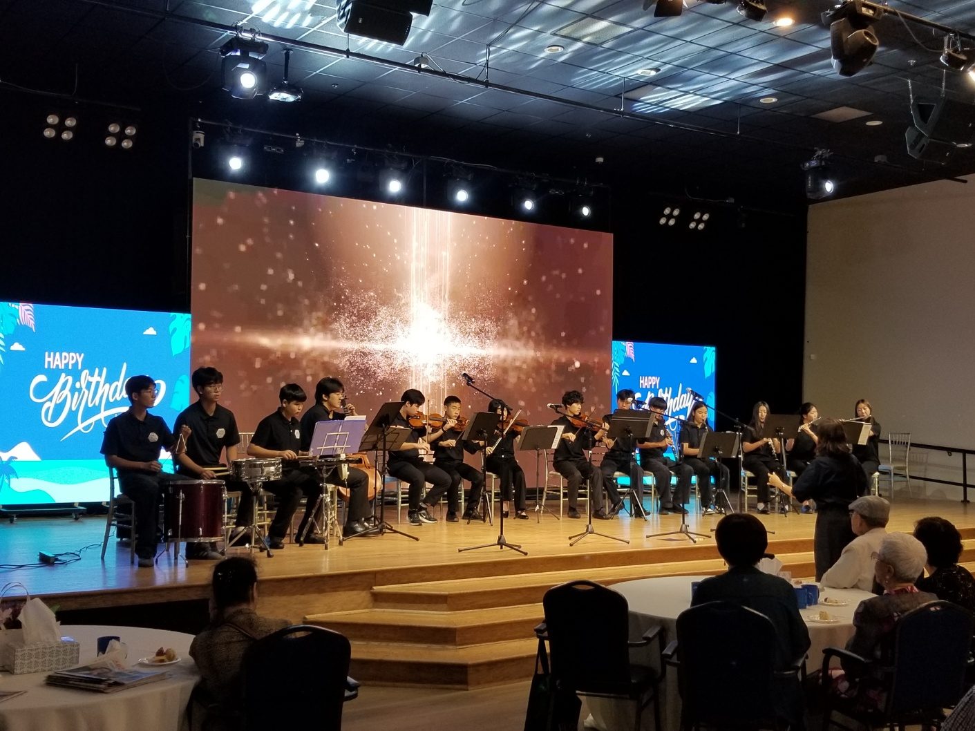 GYCO string, wind, and percussion players performing birthday music for the Joynus Daycare community